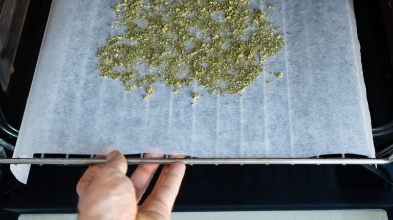 person putting weed into the oven for decarbing