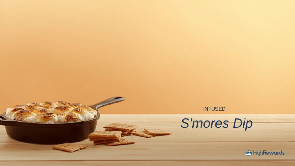 Baked s’mores dip with toasted marshmallows in a cast iron skillet with graham crackers