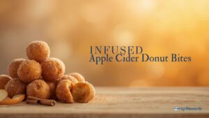 A pile of cinnamon-sugar apple cider donut bites on a wooden board with a warm golden backdrop and the words INFUSED Apple Cider Donut Bites